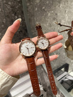 Longines watch with white dial and brown leather strap, round case on hand