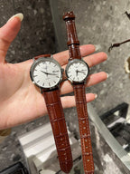 Longines watch with white dial and brown leather strap, two round cases on hand