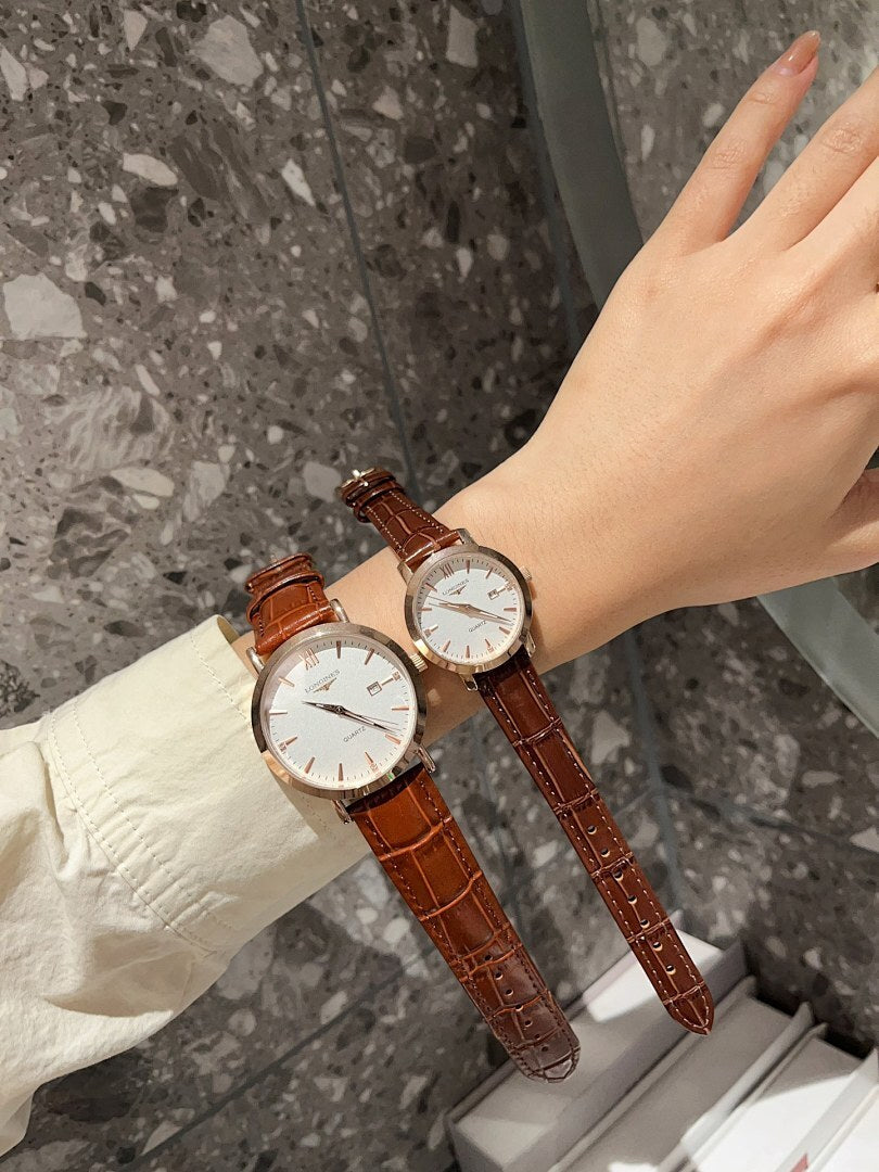 Longines watch with white dial and brown leather strap, round cases on wrist