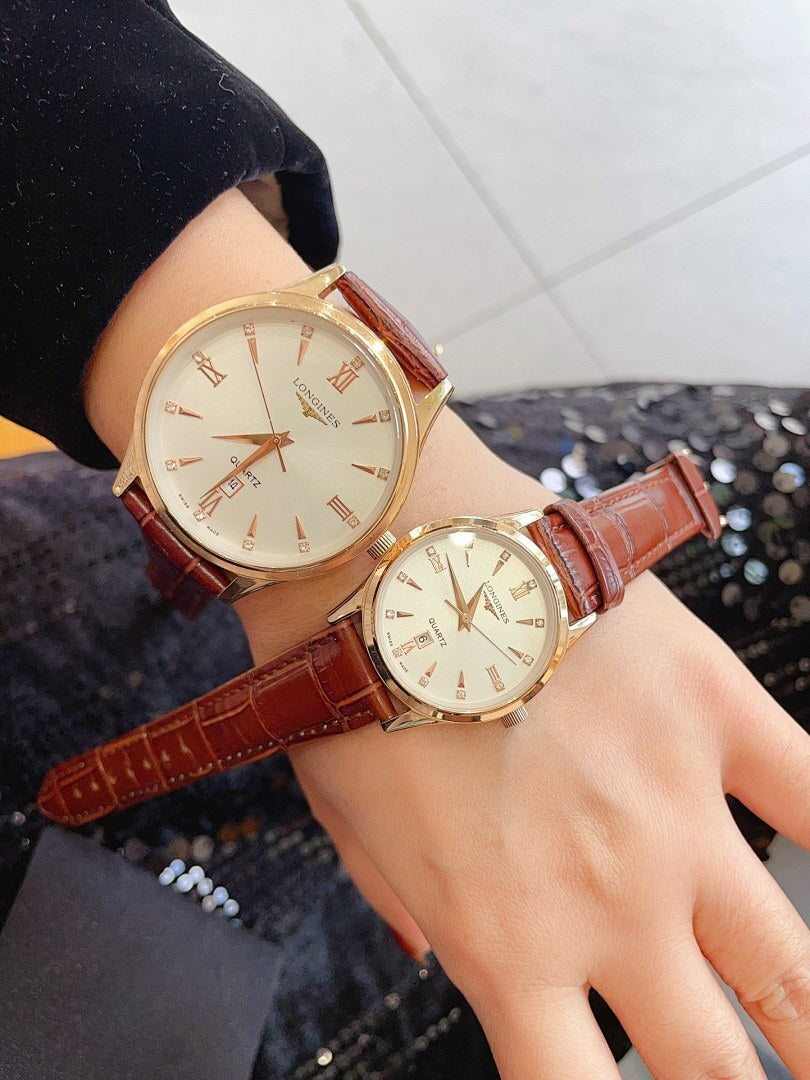 Longines watch on wrist with brown leather strap, gold case, white dial