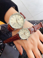 Pair of Longines watches with white dials and brown leather straps, silver cases