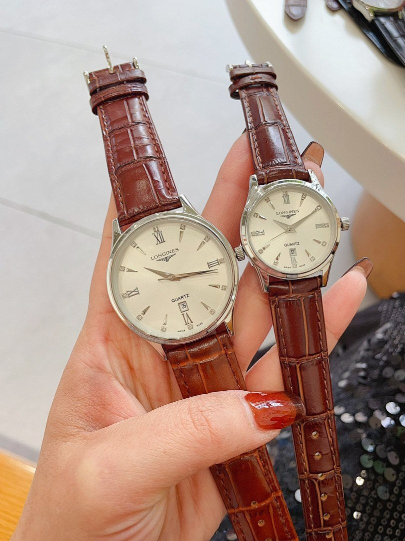 Longines watch pair with brown leather straps, gold cases, cream/white dials