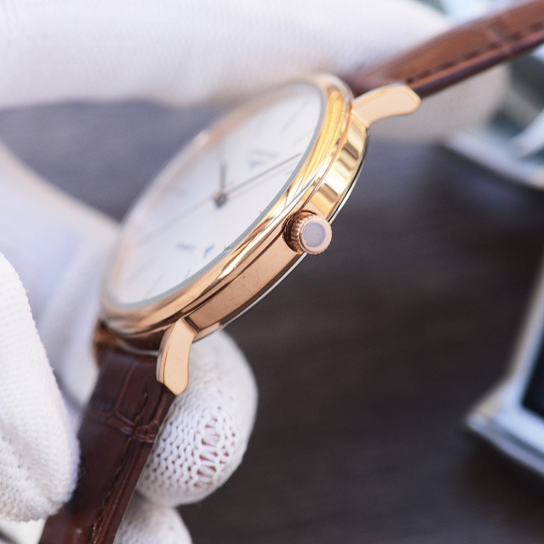 Quartz wristwatch with white dial, gold-tone case, and dark brown leather strap, side view