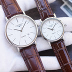 Quartz wristwatch pair with white dials and dark brown leather straps, gold-tone cases