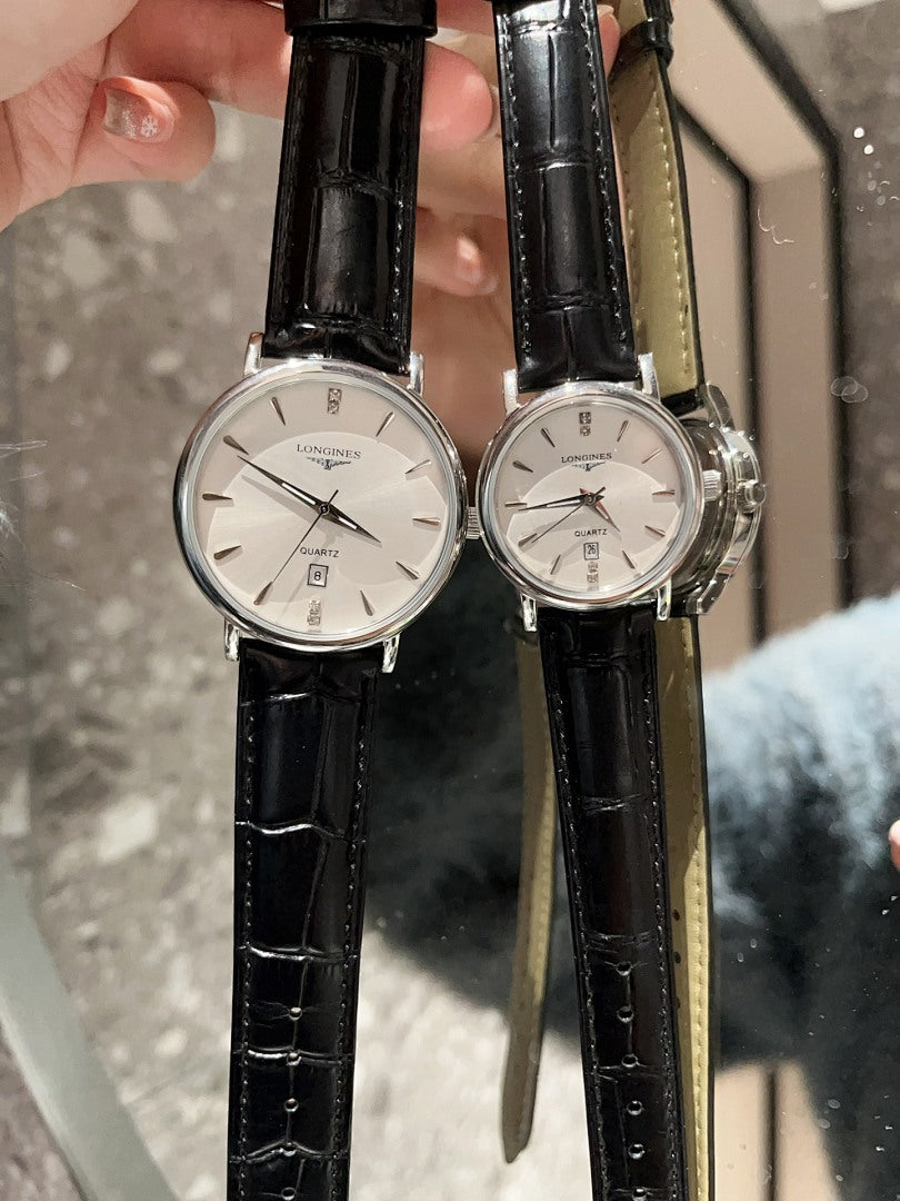 Analog wristwatches with white dials and black leather straps, close-up