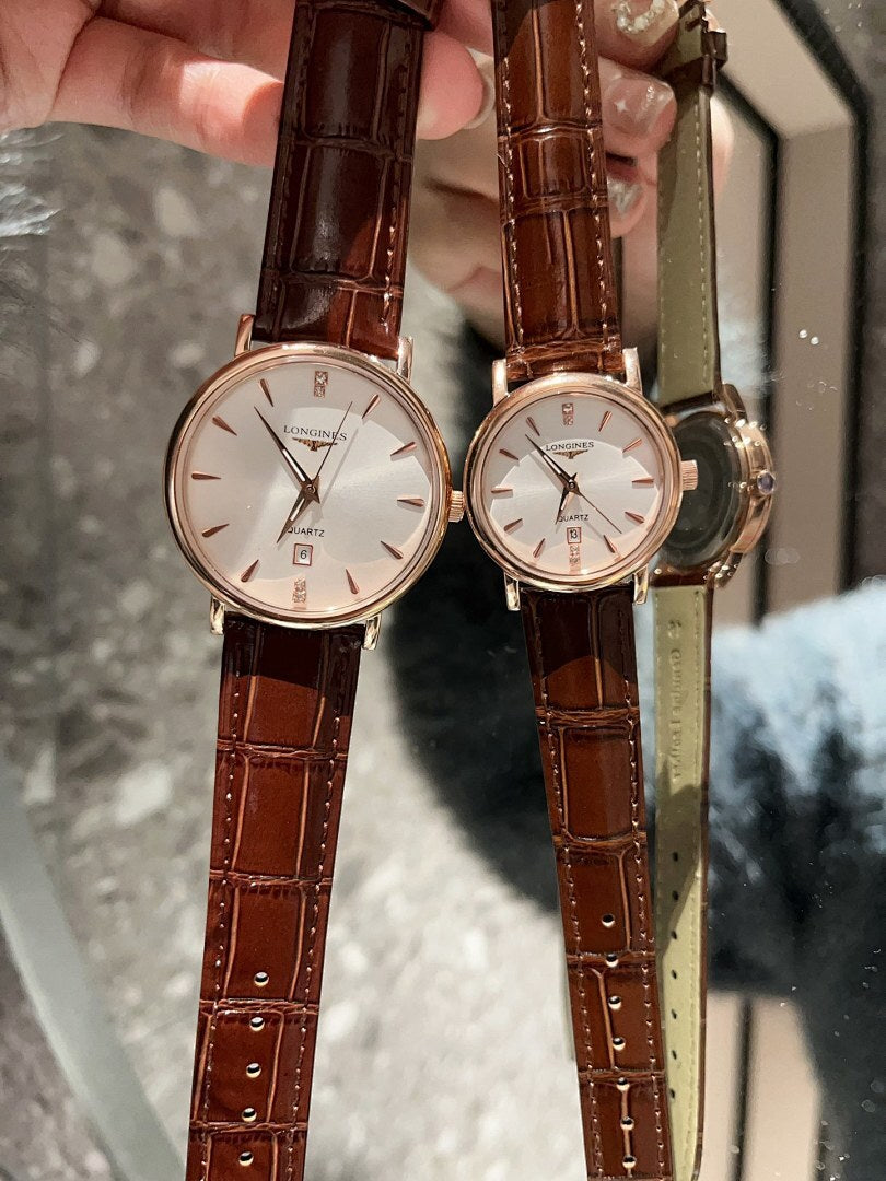 Analog wristwatches with white dials and brown leather straps, gold cases