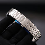 Metal watch bracelet with blue enamel inlay on link, silver-toned