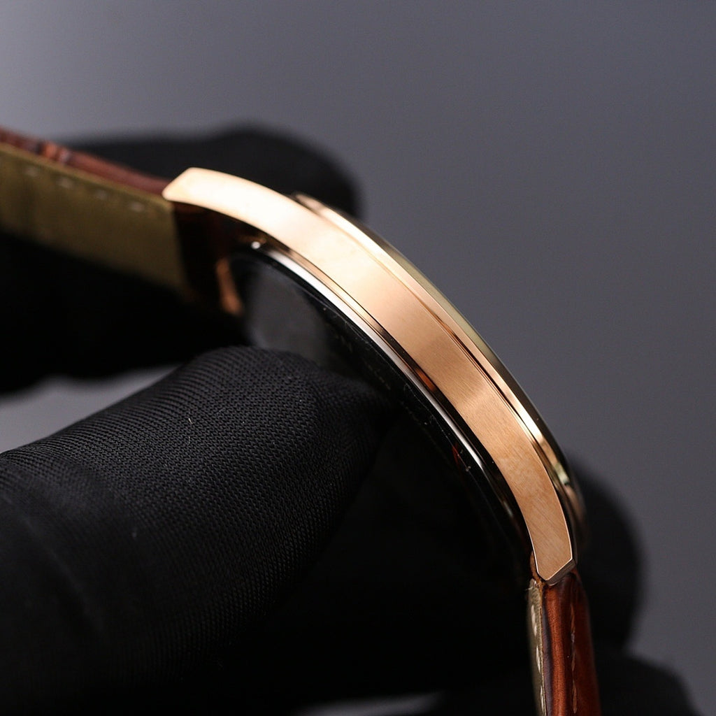 Round watch case with rose-gold bezel detail, polished edge