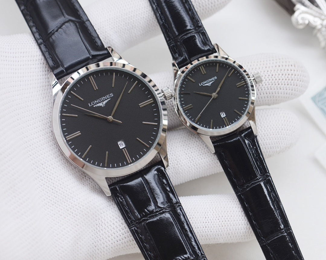 Longines watches with black leather straps and black dials, silver cases, two watches