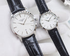 Longines watches with black leather straps, white dials, and silver cases, two watches