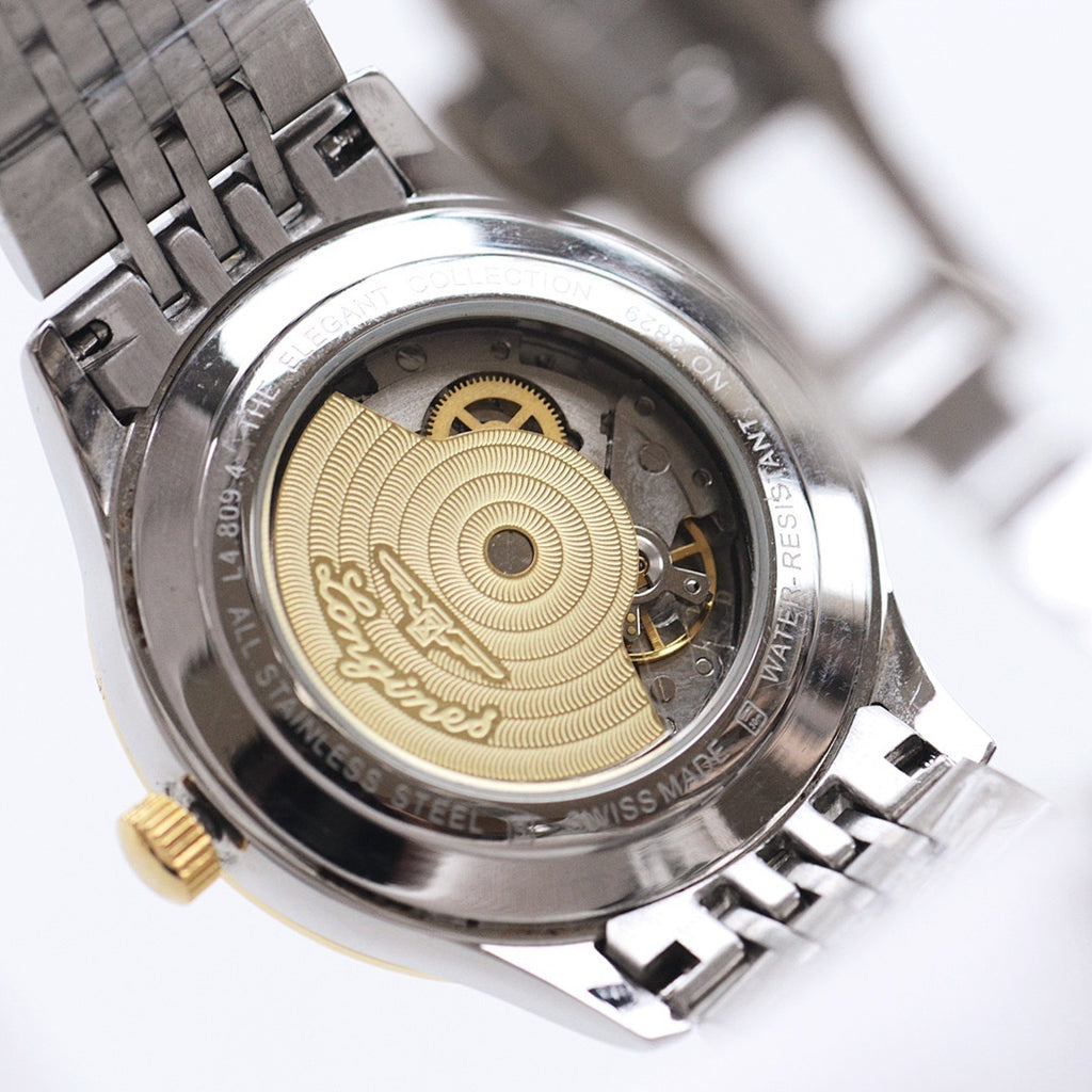 Longines automatic wristwatch case back with gold-toned rotor and exposed movement