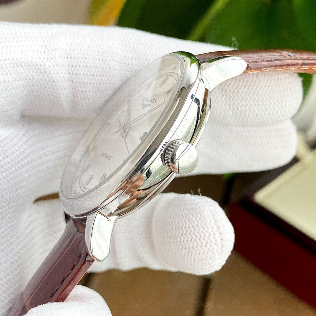 Longines watch side view with clear crystal and brown leather strap.