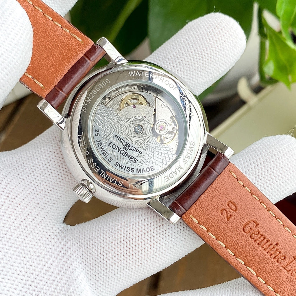 Longines watch caseback with water-resistant text and brown leather strap.