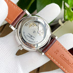 Longines watch caseback with water-resistant text and brown leather strap.