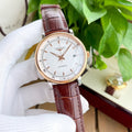 Longines watch with white dial and brown leather strap, rose-gold tone case.