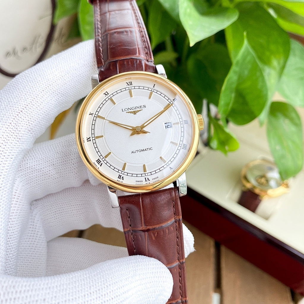 Longines watch with white dial and brown leather strap, gold-tone case.