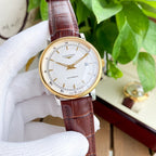 Longines watch with white dial and brown leather strap, gold-tone case.