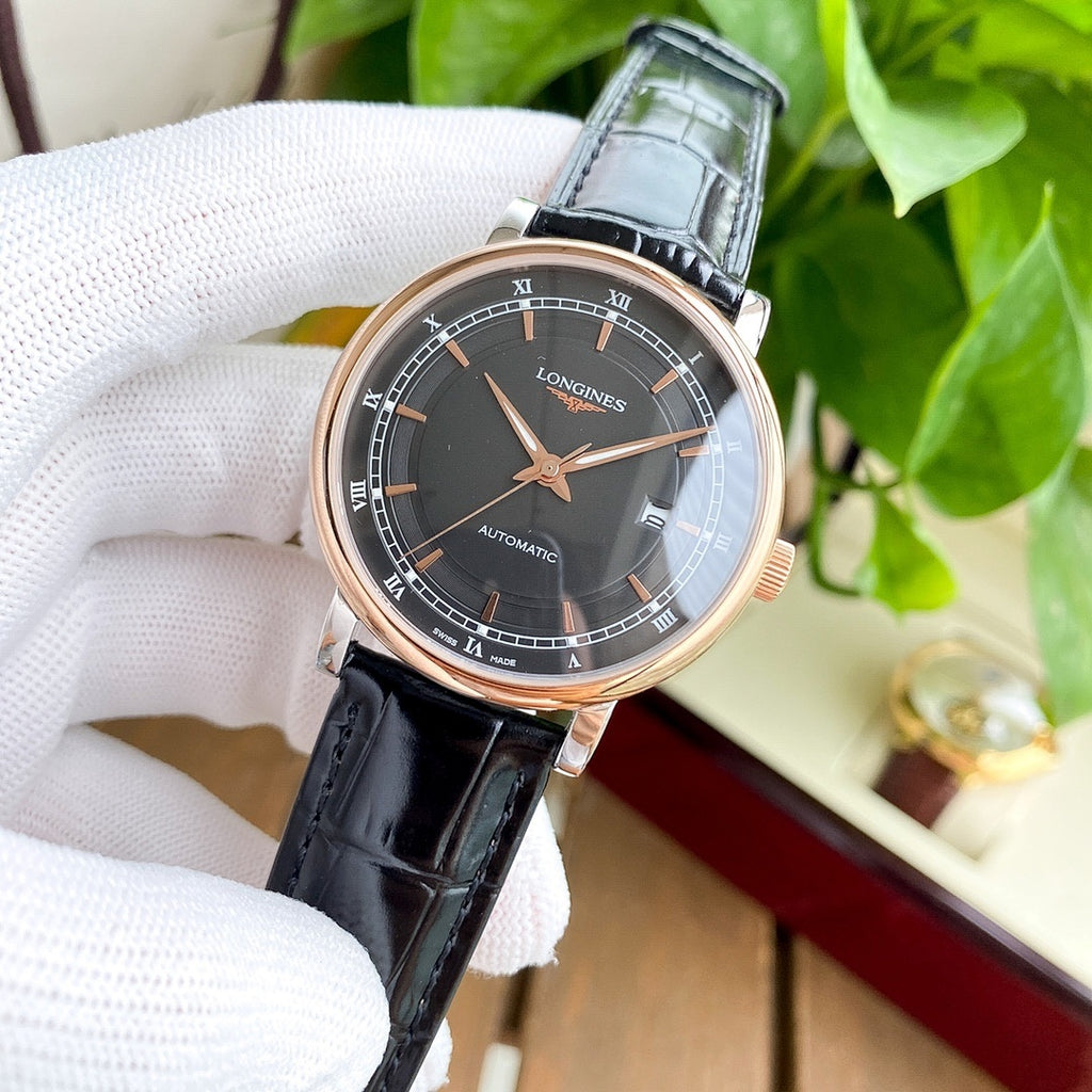 Longines watch with dark dial and black leather strap, rose-gold tone case.