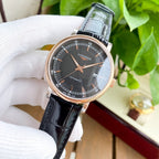 Longines watch with dark dial and black leather strap, rose-gold tone case.