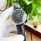 Longines watch with dark dial and black leather strap, silver-tone case.