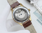 Longines watch case back, gold tone with brown leather strap, visible mechanical movement