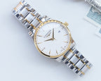 Two-tone stainless steel wristwatch with white dial and gold accents, three-hand