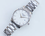 Two-tone stainless steel wristwatch with white dial and gold accents, full view