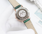 Longines watch caseback with engraved logo and text, on green and beige strap