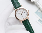 Longines watch with green leather strap, rose-gold case, and white dial