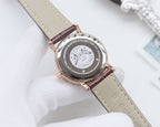 Longines watch back case on light brown leather strap, circular engraved medallion