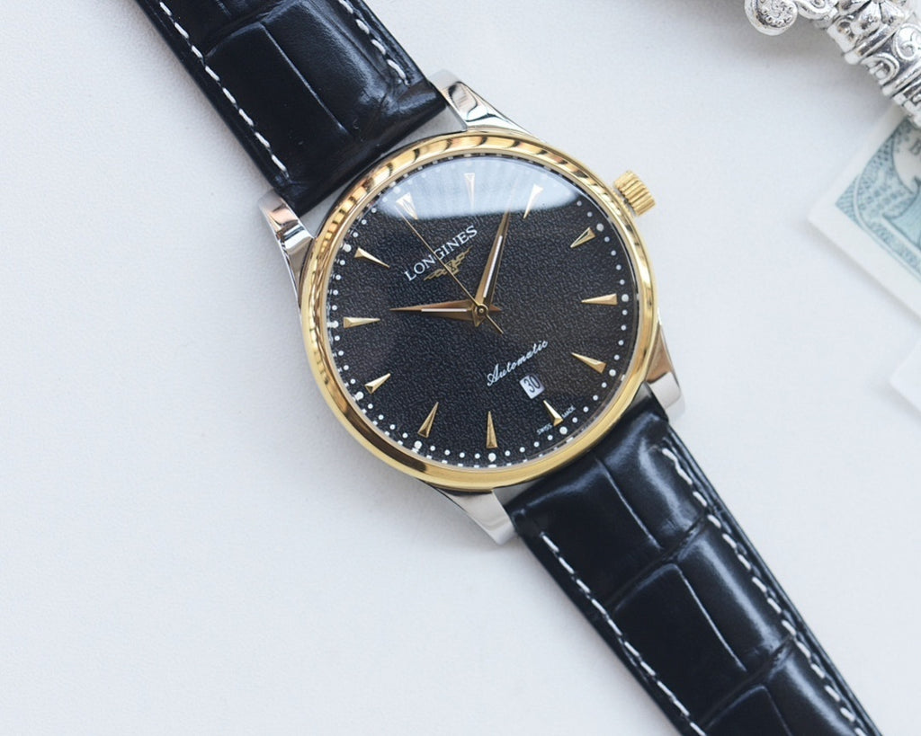 Gold-tone analog watch with dark blue dial, black leather strap, baton hour markers.
