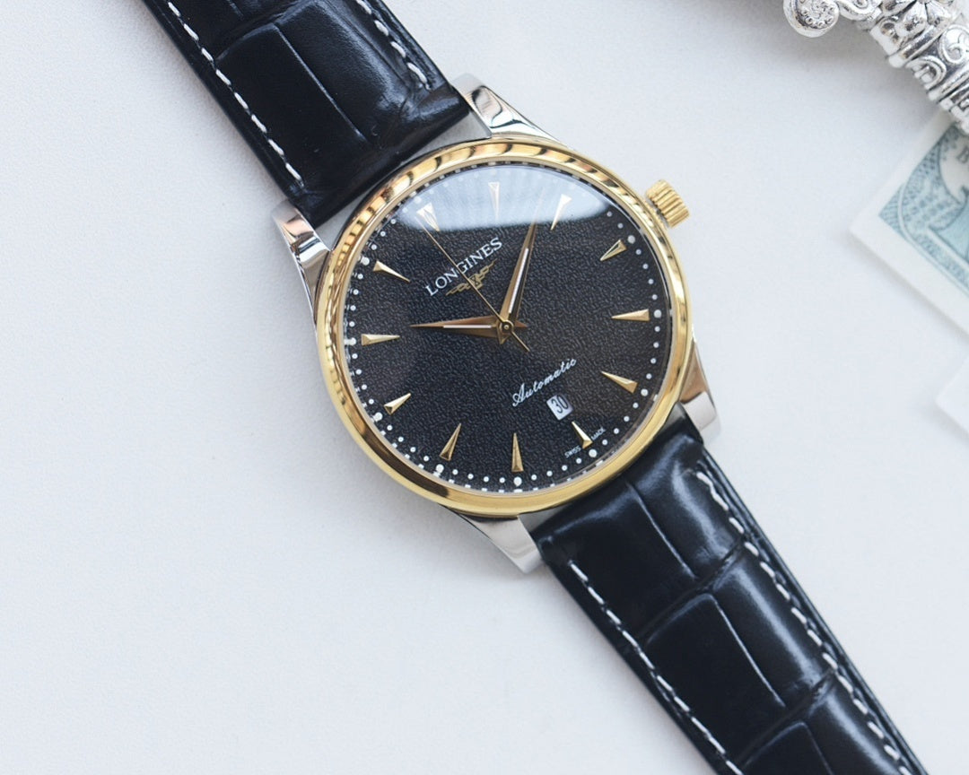 Gold-tone analog watch with dark blue dial, black leather strap, baton hour markers.