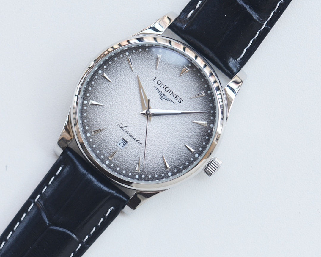 Analog watch with silver-blue textured dial, black leather strap, steel case.