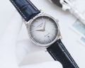Longines analog watch with blue dial, black leather strap, silver bezel and crown.
