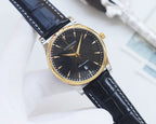 Gold-tone analog watch with dark navy dial, black leather strap, gold baton markers.