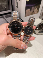 Longines watch pair with silver metal bracelets; black dials and warm rose-gold cases