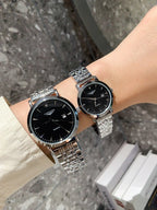 Longines watch pair on wrists with silver metal bracelets and black dials
