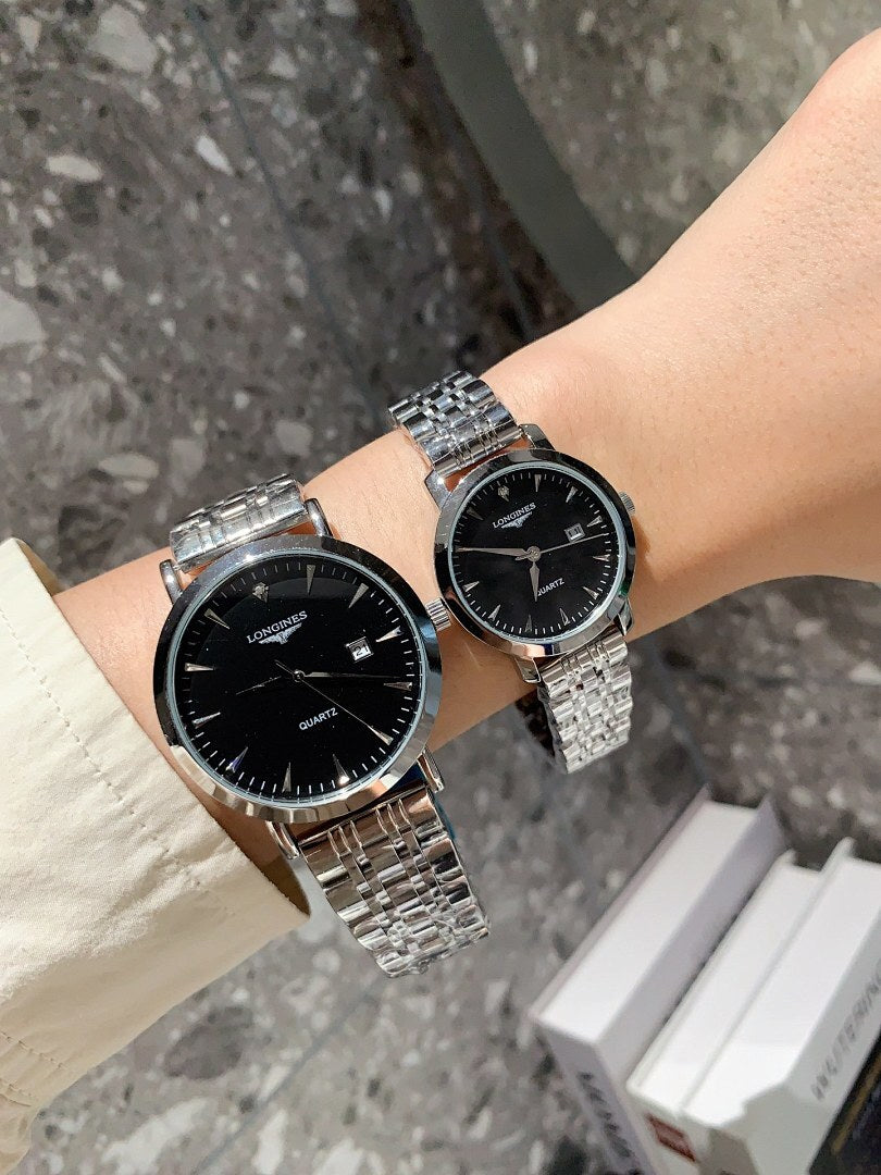 Longines watch pair on wrists with silver metal bracelets and black dials