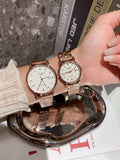 Longines wrist watches with rose-gold tone metal bracelets and white dials, one shown upright