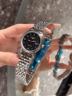 Longines stainless-steel wrist watch with black dial and silver metal bracelet, crown side shown