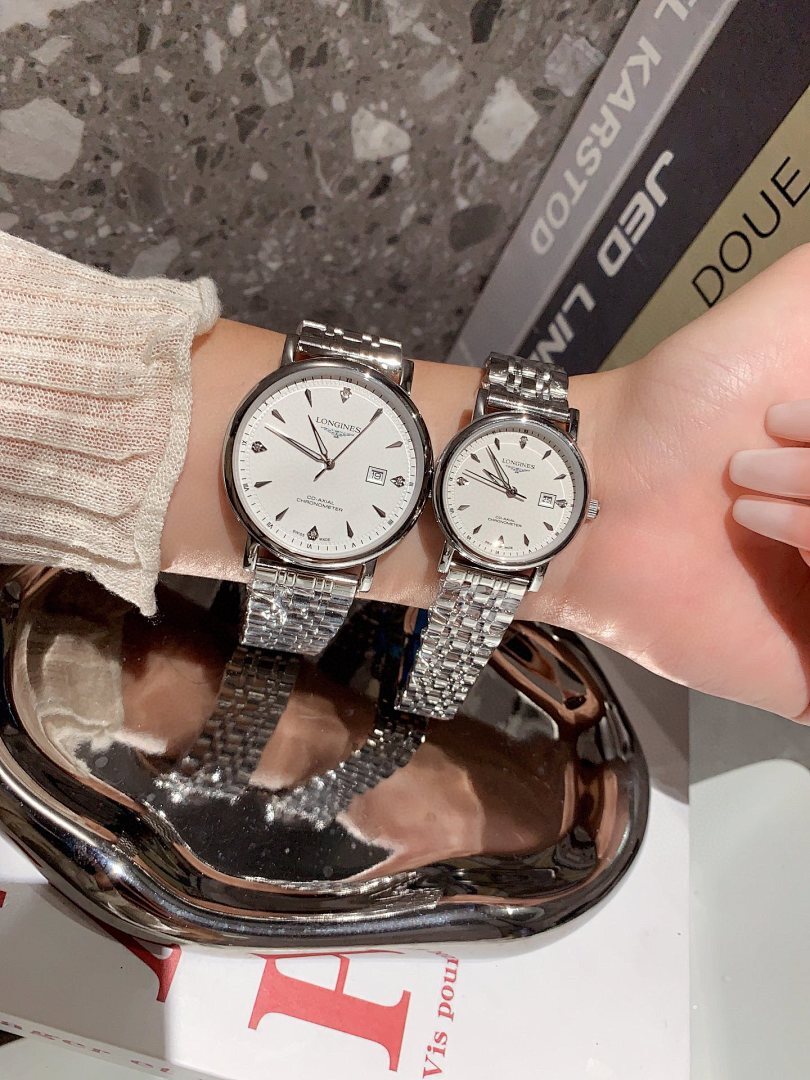 Longines wrist watches with silver and rose-gold tone metal bracelets, white dials, twin view