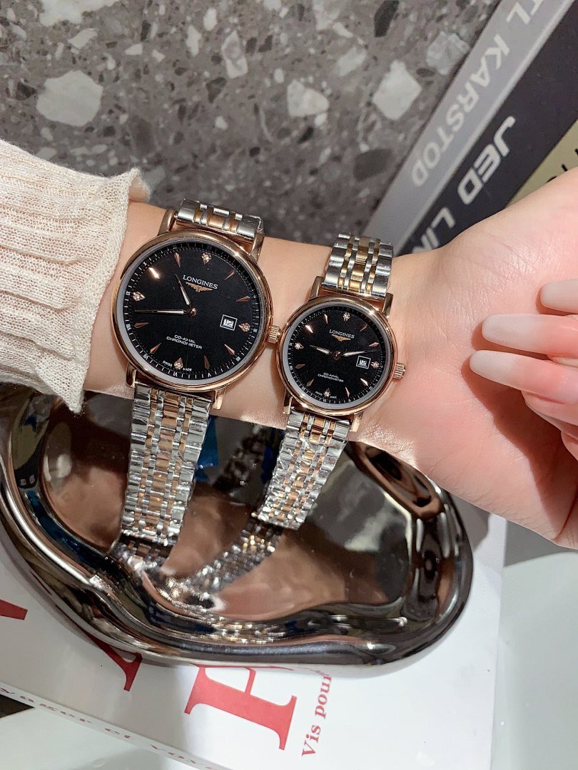 Longines wrist watches with black dials and silver metal bracelets, rose-gold tone case shown