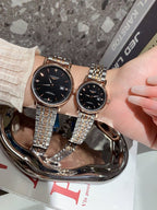 Longines wrist watches with black dials and silver metal bracelets, rose-gold tone case shown