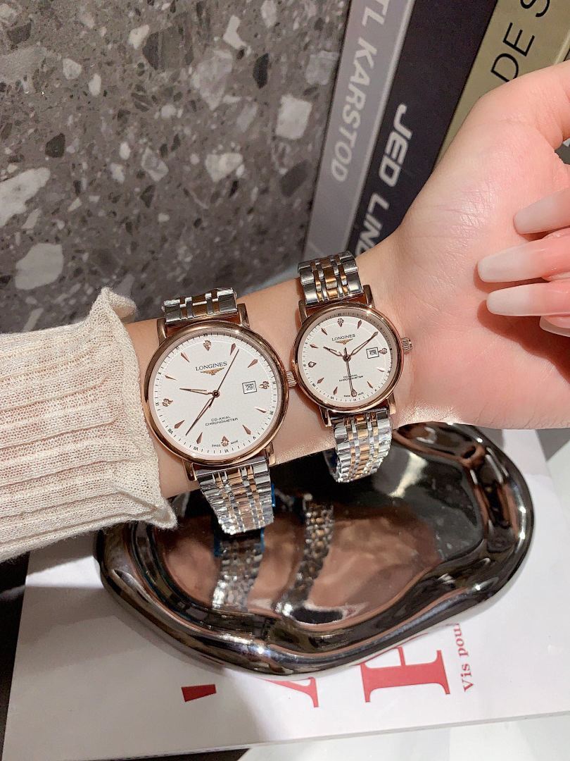 Longines wrist watches with white dials and silver metal bracelets, two rose-gold tone cases