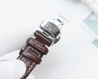 Longines watch with brown leather strap and silver buckle clasp