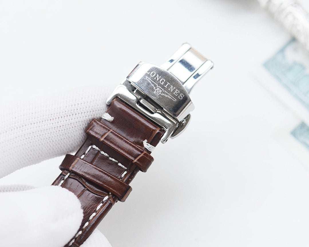 Longines watch with brown leather strap and silver buckle clasp