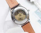 Longines automatic watch caseback with visible movement and brown leather strap