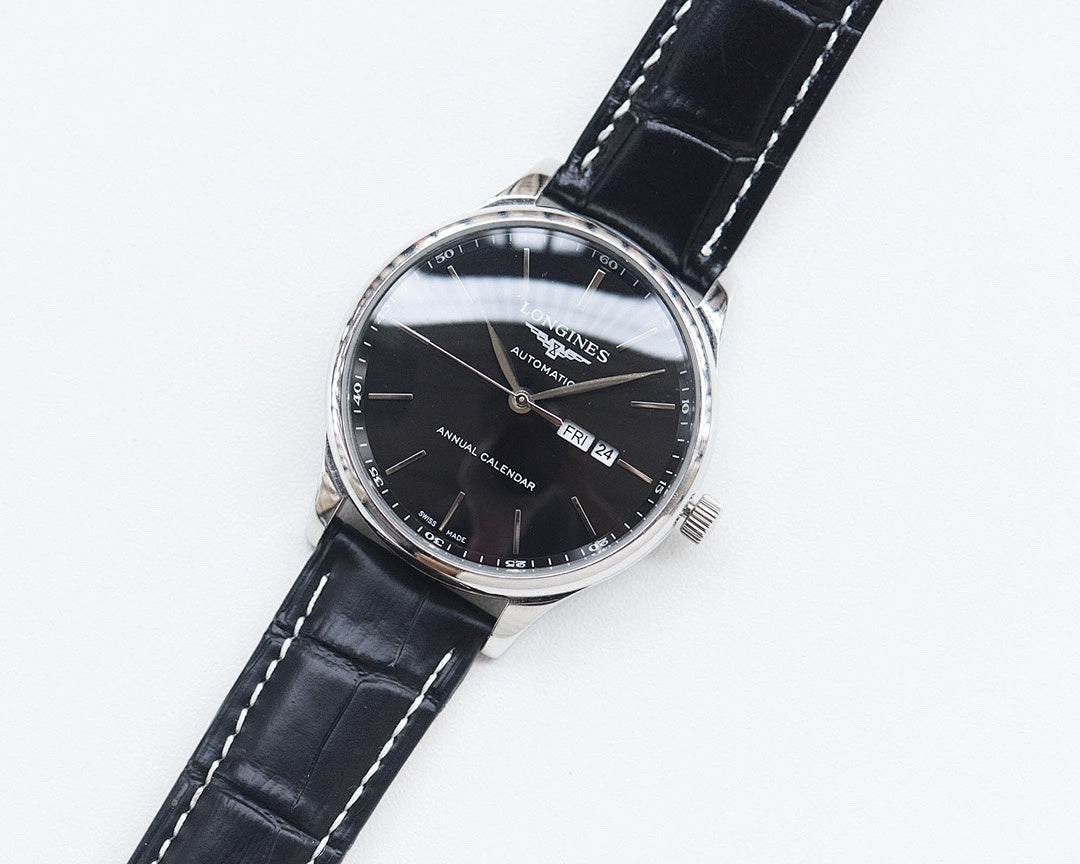 Longines automatic watch with black dial and black leather strap, round silver case