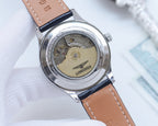 Watch case back with exposed movement window and tan leather strap, round silver