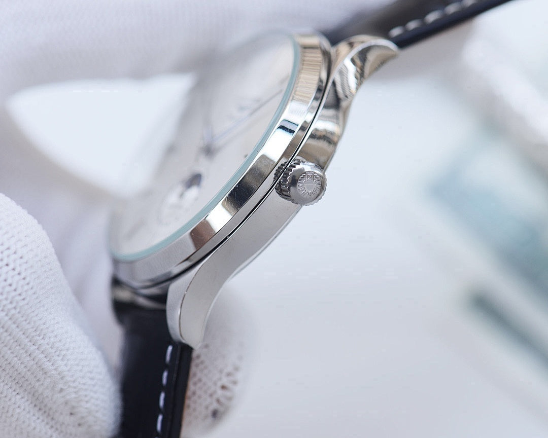 Longines watch case side with crown and black leather strap, polished metal